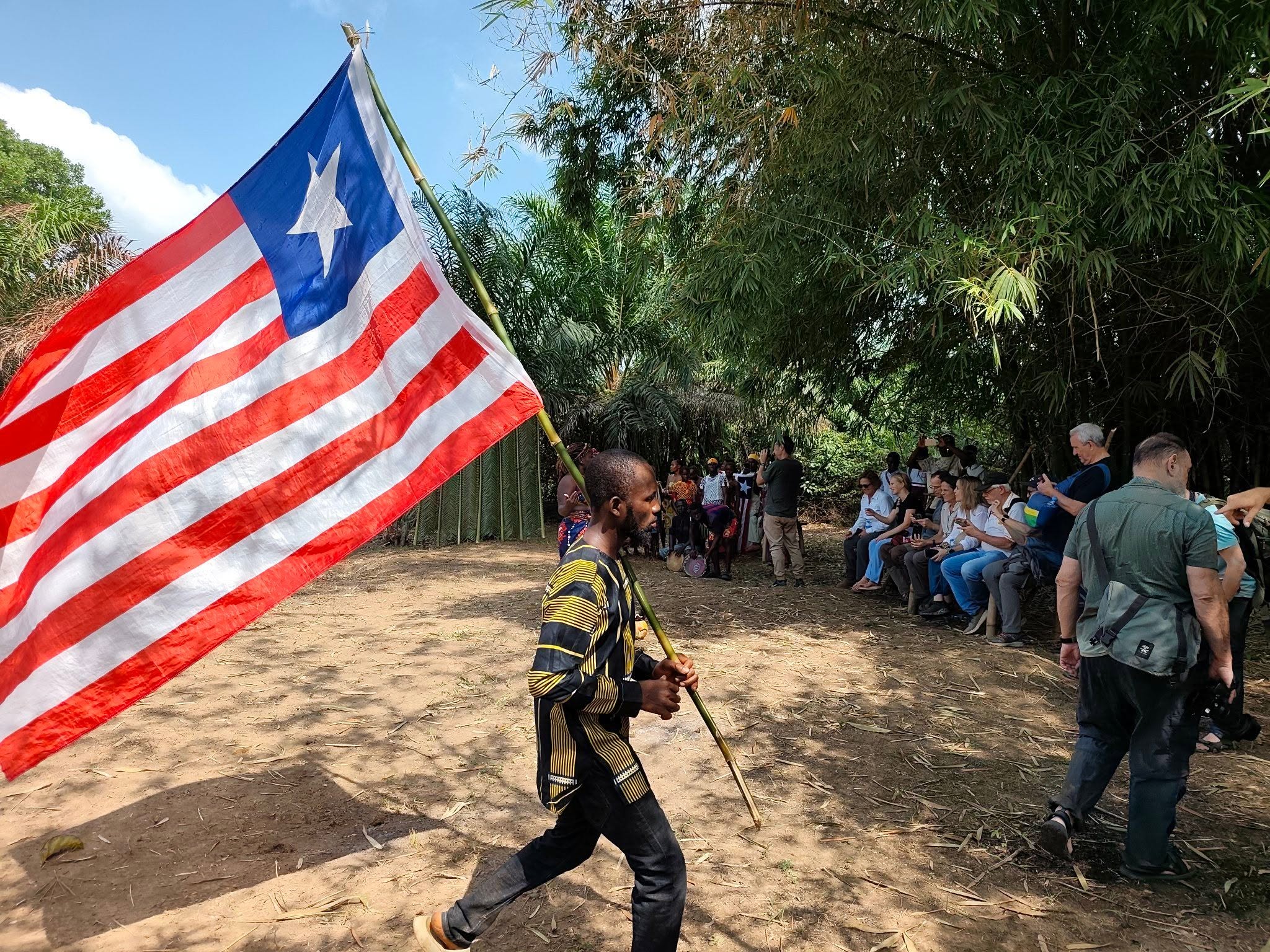 Flag bearer at a West African community gathering