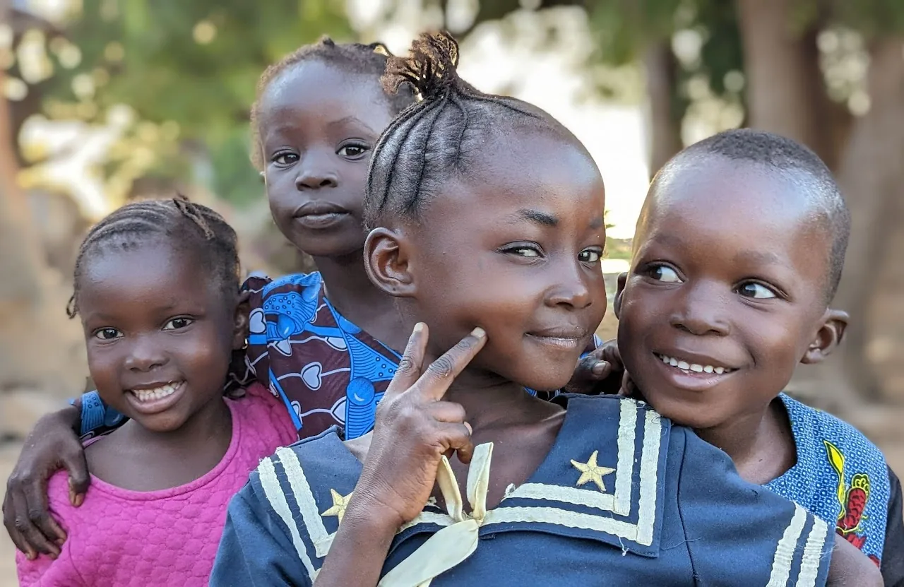 Children smiling in a village in Mali