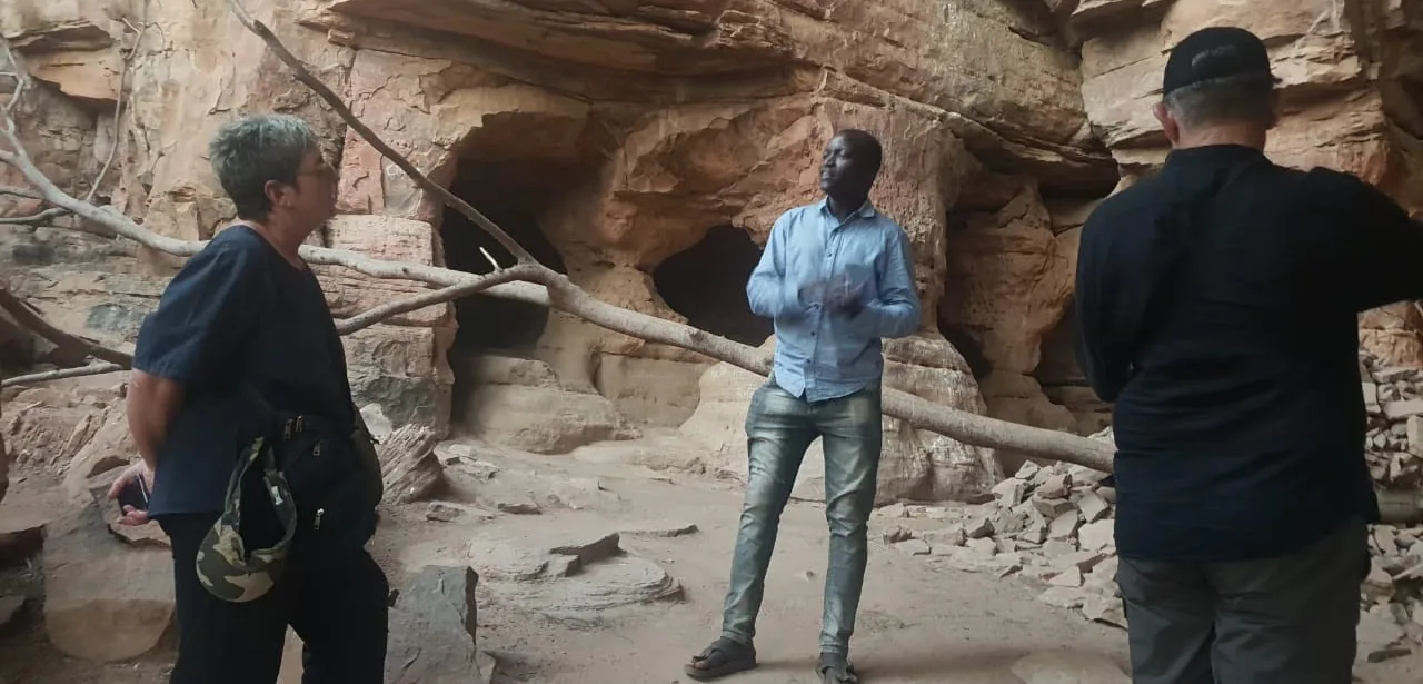 Guide and travellers on a dirt road in Mali