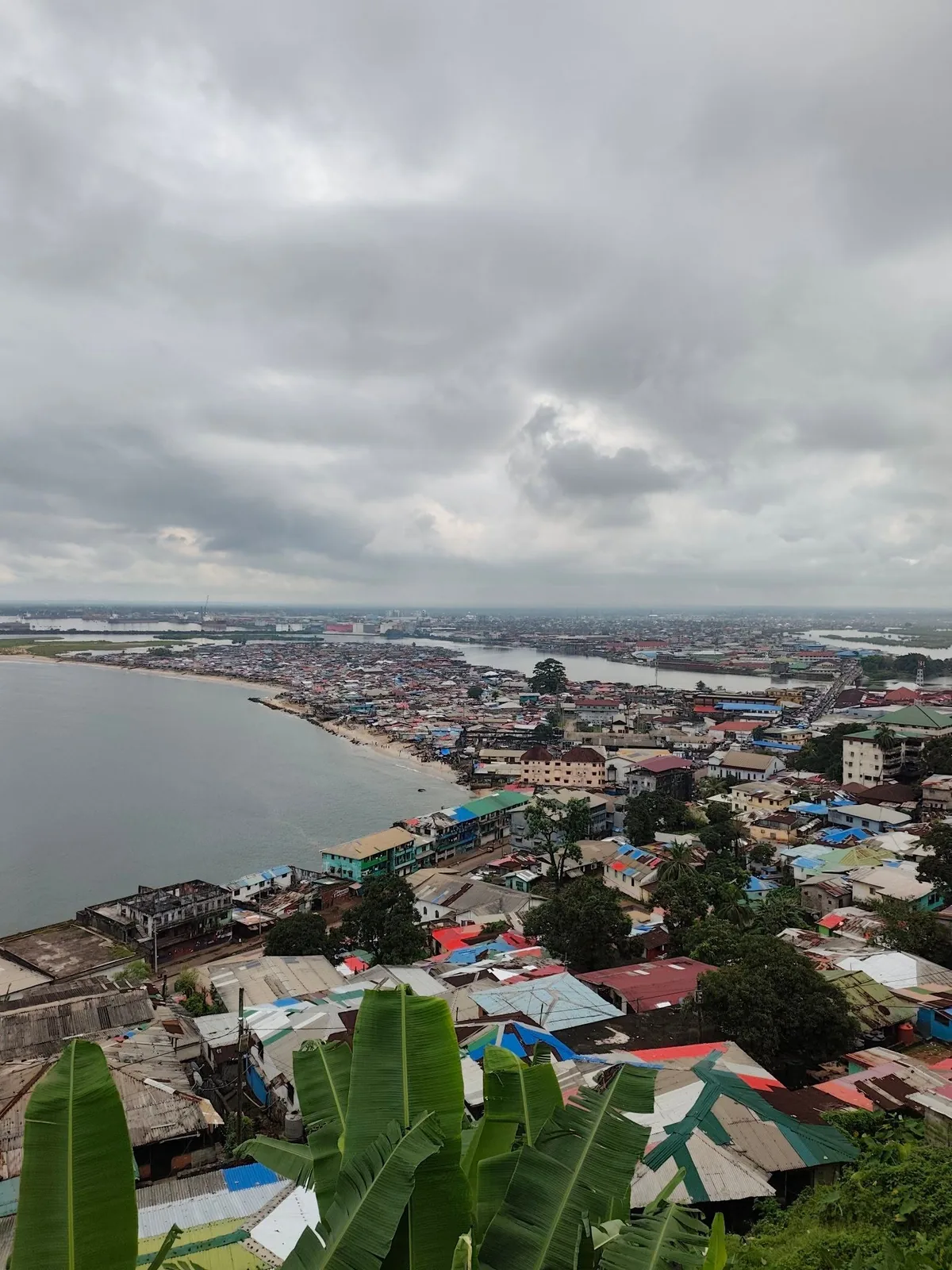 Hilltop view over a West African coastal city and river mouth