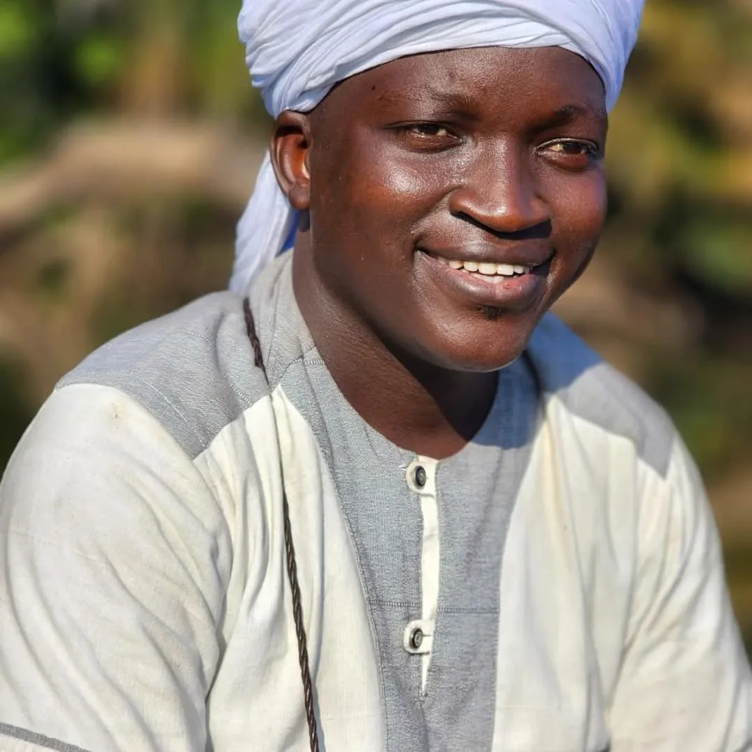 Portrait of a Guinean guide smiling outdoors